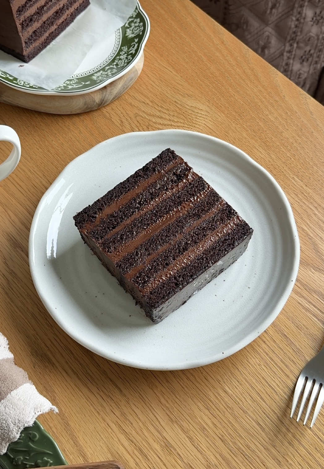 Long awaited recipe, this Chocolate Moist Cake layered with Dark Chocolate Cremeux and Cream Cheese fillings. It’s super moist, rich with chocolate flavour and so easy to make too! 🍫🤎 Chocolate moist cake 250g (1 1/4 cup) brown sugar 160ml (2/3 cup) buttermilk  160ml (2/3 cup) vegetable oil 120g (1/2 cup) plain yogurt  2 large eggs  1 tsp vanilla  280g (2 1/3 cup) all-purpose flour  1 tsp baking powder 2 tsp baking soda  1/2 tsp salt 250ml (1 cup) hot water 1 tbsp instant coffee  50g (1/2 cup) cocoa powder  *Bake 30-35 minutes  Chocolate cremeux 200g dark chocolate  120ml (1/2 cup) milk 120ml (1/2 cup) whipping cream 2 eggs + 1 yolk 25g (2 tbsp) sugar  250g cream cheese  15g (2 tbsp) cocoa powder  30g (1/4) powdered sugar 120ml (1/2 cup) whipping cream *I’m using 13”x10” tray size to bake the cake and cut into 4”x8” loaf pan size. Slice the cake into two to get more layers.